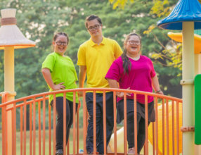 three people at the playground